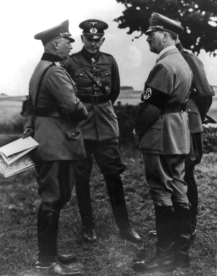 Adolf Hitler with minister of War Werner von Blomberg and Werner von Fritsch, commander in chief of the army, during army maneuvers at the Munster training camp